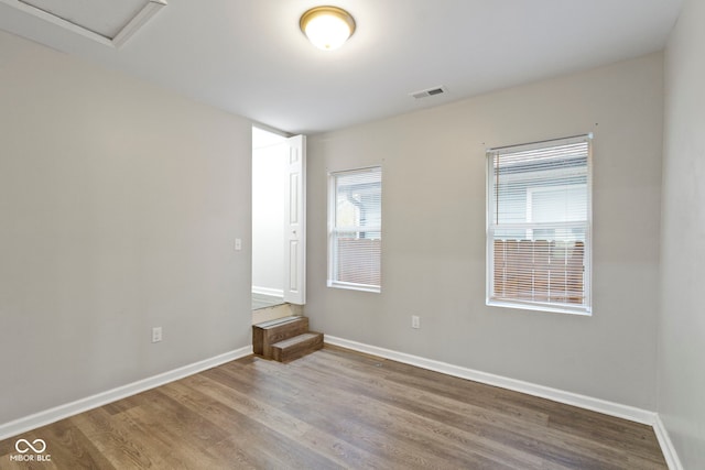802 N Tuxedo St, Indianapolis, IN 46201 - unfurnished room with wood finished floors, baseboards, and attic access