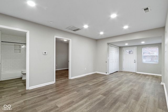 802 N Tuxedo St, Indianapolis, IN 46201 - unfurnished living room with wood finished floors, baseboards, and recessed lighting