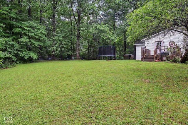 2640 S Silcox Rd, Paragon, IN 46166 - view of grassy yard featuring a trampoline and a wooden deck