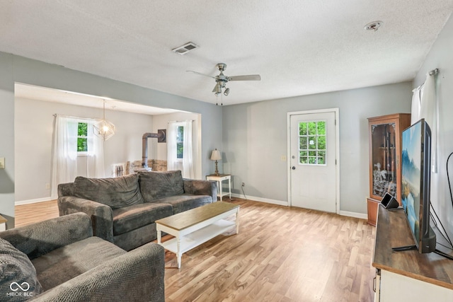 2640 S Silcox Rd, Paragon, IN 46166 - living room featuring healthy amount of natural light, light wood-type flooring, a ceiling fan, and a textured ceiling