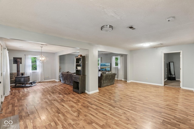 2640 S Silcox Rd, Paragon, IN 46166 - living area with a wood stove, light wood-style floors, and a textured ceiling