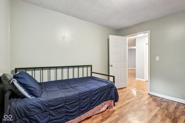 2640 S Silcox Rd, Paragon, IN 46166 - bedroom featuring wood finished floors and a textured ceiling