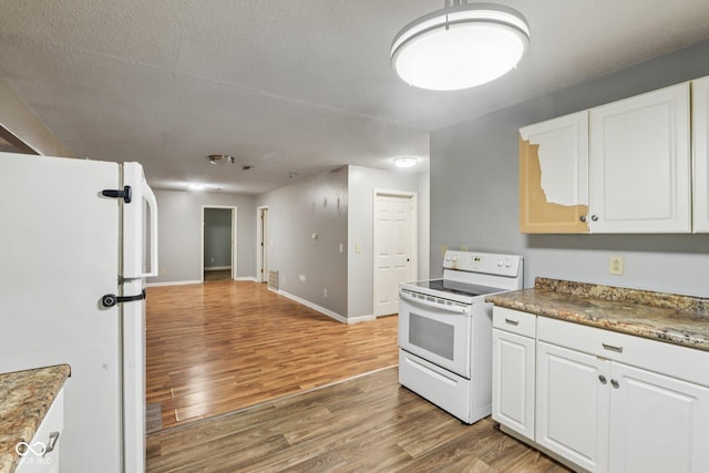2640 S Silcox Rd, Paragon, IN 46166 - kitchen featuring white appliances, light wood-style flooring, and white cabinets