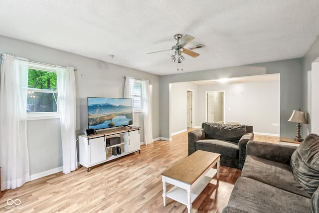 2640 S Silcox Rd, Paragon, IN 46166 - living room featuring light wood-style flooring, a ceiling fan, and a textured ceiling