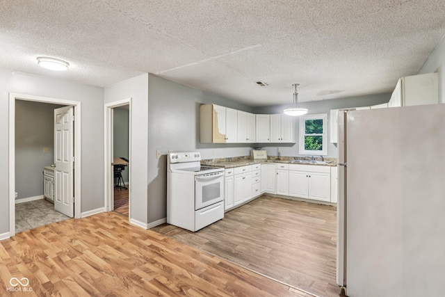 2640 S Silcox Rd, Paragon, IN 46166 - kitchen featuring white appliances, light wood-style flooring, white cabinets, light countertops, and a textured ceiling