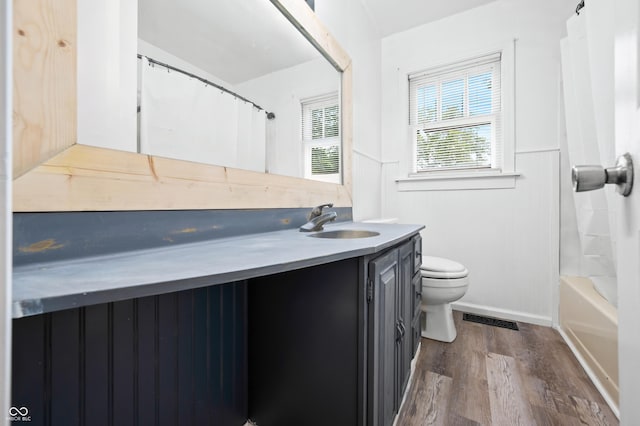 801 N Park St, Seymour, IN 47274 - full bathroom with vanity, toilet, wood finished floors, and shower / bath combo with shower curtain