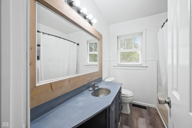 801 N Park St, Seymour, IN 47274 - bathroom with vanity, toilet, wood finished floors, and a wainscoted wall