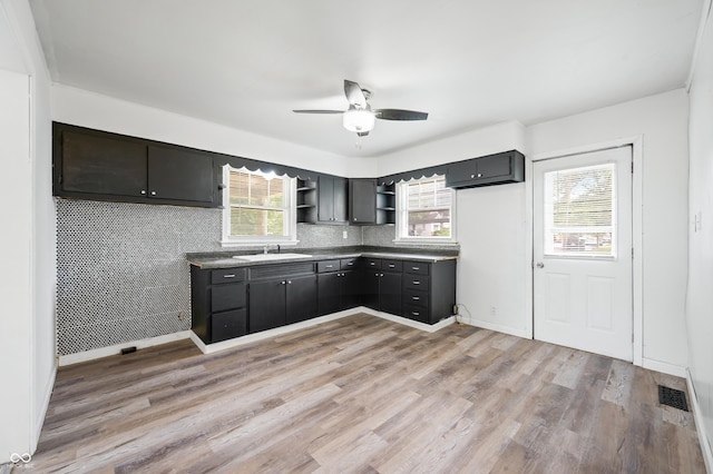 801 N Park St, Seymour, IN 47274 - kitchen featuring open shelves, a sink, light wood-style floors, a ceiling fan, and dark countertops