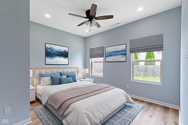 8355 Fieldfare Way, Indianapolis, IN 46237 - bedroom featuring multiple windows, baseboards, light wood finished floors, ceiling fan, and recessed lighting