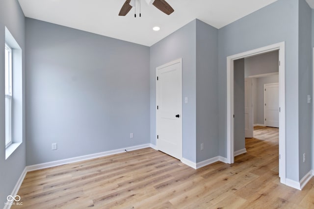 8355 Fieldfare Way, Indianapolis, IN 46237 - unfurnished bedroom featuring light wood-type flooring, baseboards, and a ceiling fan