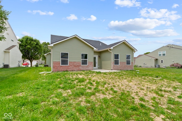 8355 Fieldfare Way, Indianapolis, IN 46237 - rear view of property featuring brick siding, central AC unit, and a yard