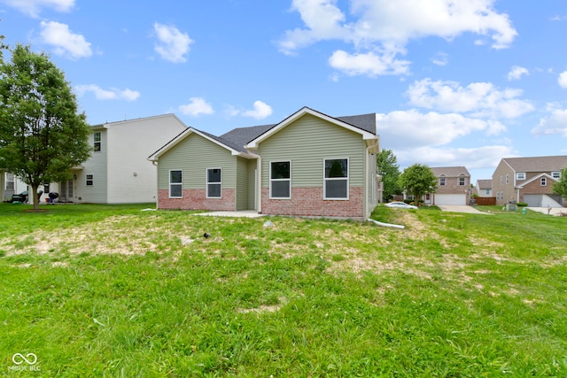 8355 Fieldfare Way, Indianapolis, IN 46237 - back of house featuring brick siding and a yard