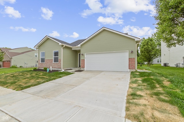 8355 Fieldfare Way, Indianapolis, IN 46237 - ranch-style home featuring a garage, driveway, brick siding, and a front yard
