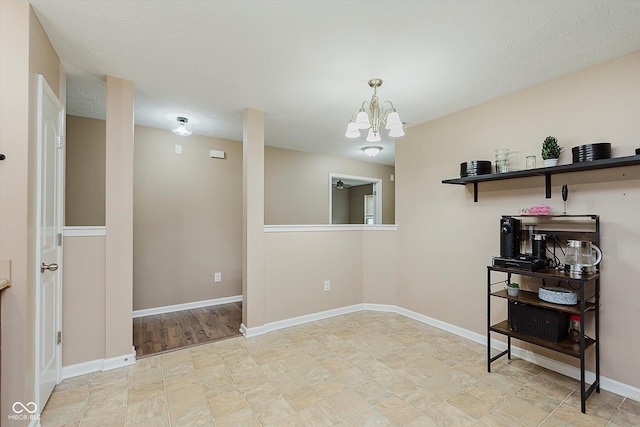 11521 Short Iron Ln, Indianapolis, IN 46235 - spare room featuring a chandelier and baseboards
