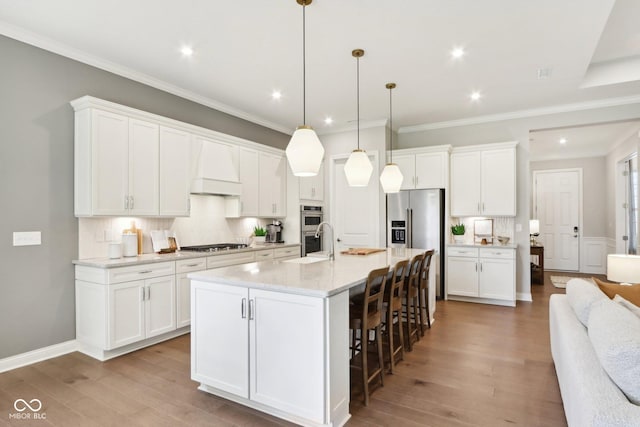 12594 Pasco St, Fishers, IN 46038 - kitchen with premium range hood, light wood-style flooring, stainless steel appliances, tasteful backsplash, and recessed lighting