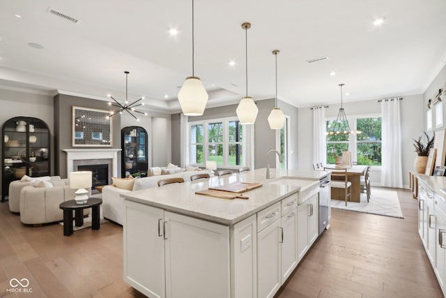 12594 Pasco St, Fishers, IN 46038 - kitchen with a chandelier, hardwood / wood-style flooring, white cabinets, recessed lighting, and crown molding