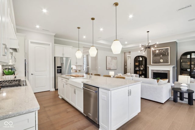 12594 Pasco St, Fishers, IN 46038 - kitchen with appliances with stainless steel finishes, light wood finished floors, crown molding, a sink, and white cabinets