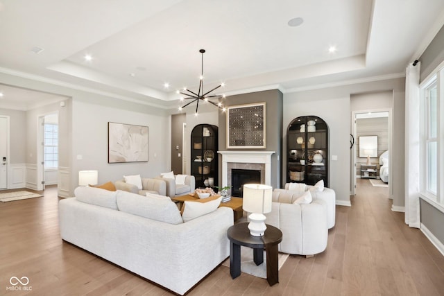 12594 Pasco St, Fishers, IN 46038 - living area featuring a raised ceiling, wood finished floors, a chandelier, healthy amount of natural light, and recessed lighting