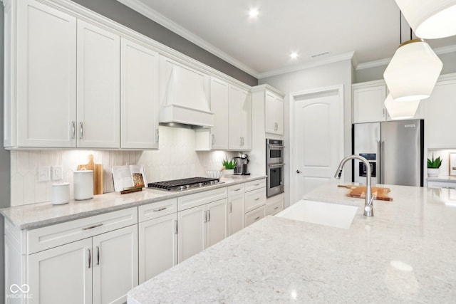 12594 Pasco St, Fishers, IN 46038 - kitchen featuring stainless steel appliances, a sink, custom range hood, white cabinetry, and ornamental molding