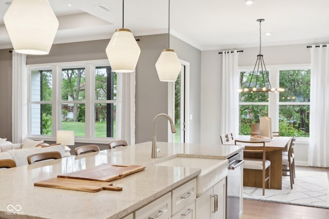 12594 Pasco St, Fishers, IN 46038 - kitchen with a sink, light stone countertops, white cabinets, pendant lighting, and recessed lighting