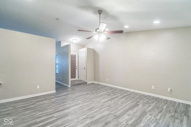 11114 Wismar Dr, Indianapolis, IN 46235 - spare room featuring a ceiling fan, wood finished floors, baseboards, recessed lighting, and lofted ceiling