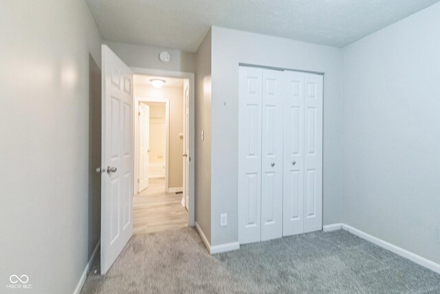 11114 Wismar Dr, Indianapolis, IN 46235 - unfurnished bedroom featuring baseboards, light colored carpet, and a closet