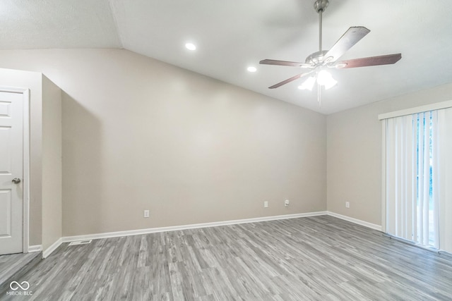 11114 Wismar Dr, Indianapolis, IN 46235 - spare room with lofted ceiling, wood finished floors, a ceiling fan, baseboards, and recessed lighting