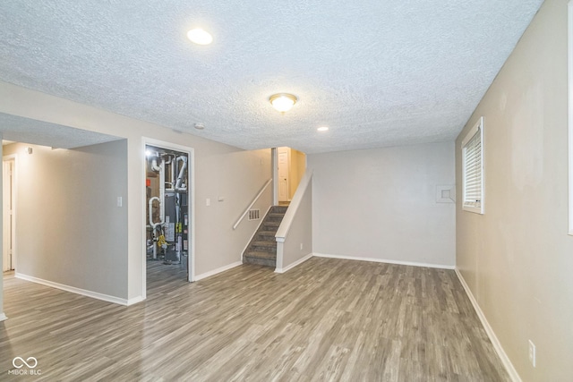 11114 Wismar Dr, Indianapolis, IN 46235 - finished basement featuring light wood-type flooring, a textured ceiling, stairs, baseboards, and recessed lighting