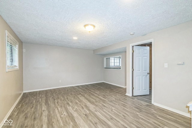 11114 Wismar Dr, Indianapolis, IN 46235 - spare room with a textured ceiling, light wood finished floors, and baseboards
