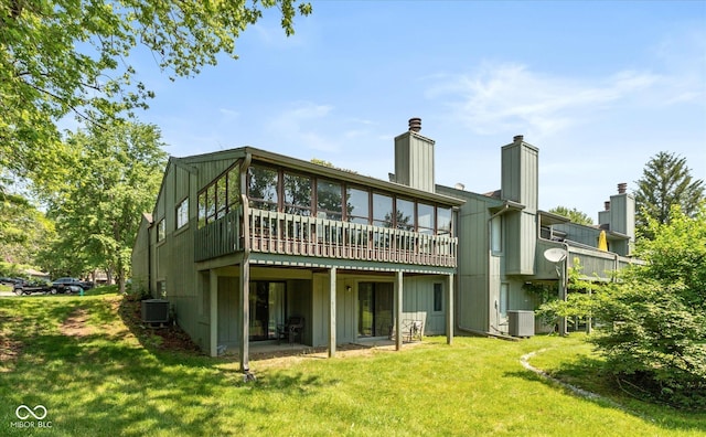 4965 Hawthorne Way, Avon, IN 46123 - back of property featuring a yard, a wooden deck, a chimney, and board and batten siding