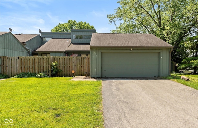 4965 Hawthorne Way, Avon, IN 46123 - mid-century home featuring asphalt driveway, an attached garage, a shingled roof, and board and batten siding