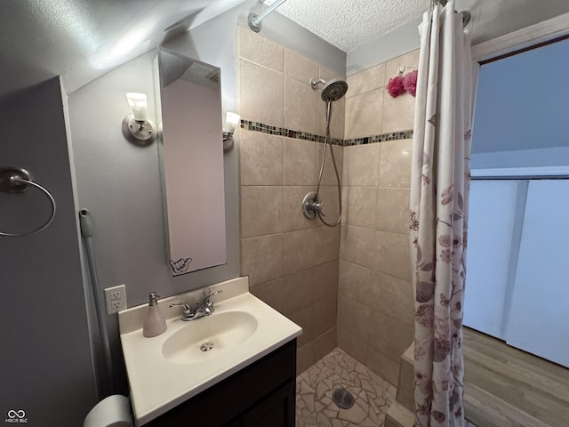 537 N 17th St, Noblesville, IN 46060 - full bath featuring a textured ceiling, vanity, a tile shower, and wood finished floors