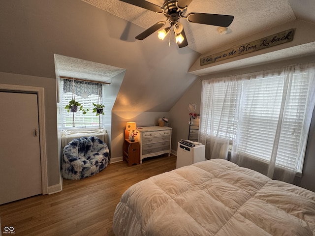 537 N 17th St, Noblesville, IN 46060 - bedroom with multiple windows, vaulted ceiling, wood finished floors, ceiling fan, and a textured ceiling