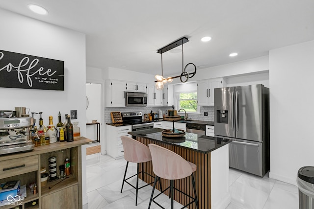 3141 Citadel Ct, Indianapolis, IN 46268 - kitchen with stainless steel appliances, light marble finish floors, white cabinetry, tasteful backsplash, and a kitchen breakfast bar