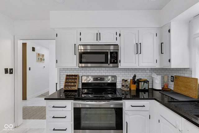 3141 Citadel Ct, Indianapolis, IN 46268 - kitchen with stainless steel appliances, light marble finish flooring, white cabinetry, and decorative backsplash