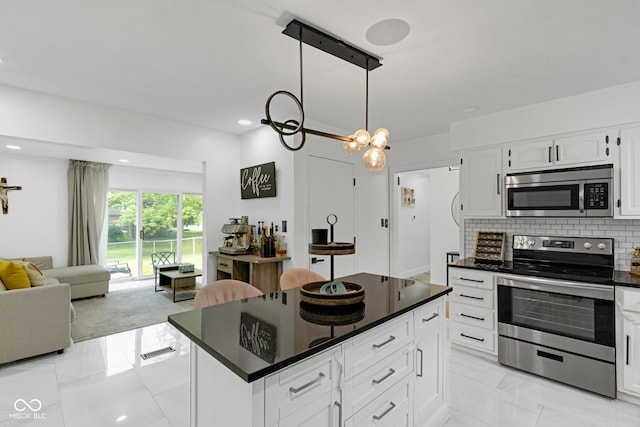 3141 Citadel Ct, Indianapolis, IN 46268 - kitchen featuring stainless steel appliances, dark countertops, light marble finish floors, backsplash, and open floor plan