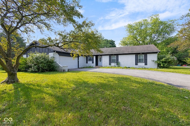 3141 Citadel Ct, Indianapolis, IN 46268 - ranch-style home featuring driveway, brick siding, an attached garage, and a front yard