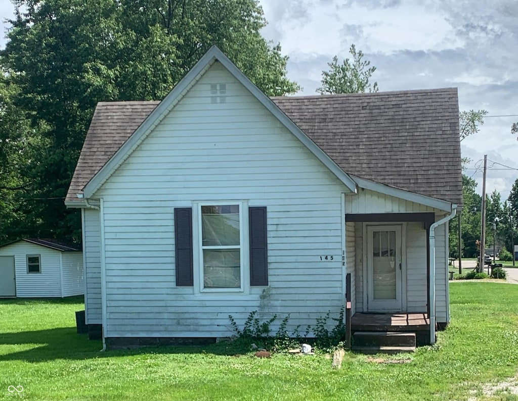 145 Hayden Pike, North Vernon, IN 47265 - bungalow-style house featuring a shingled roof, a front yard, and a porch