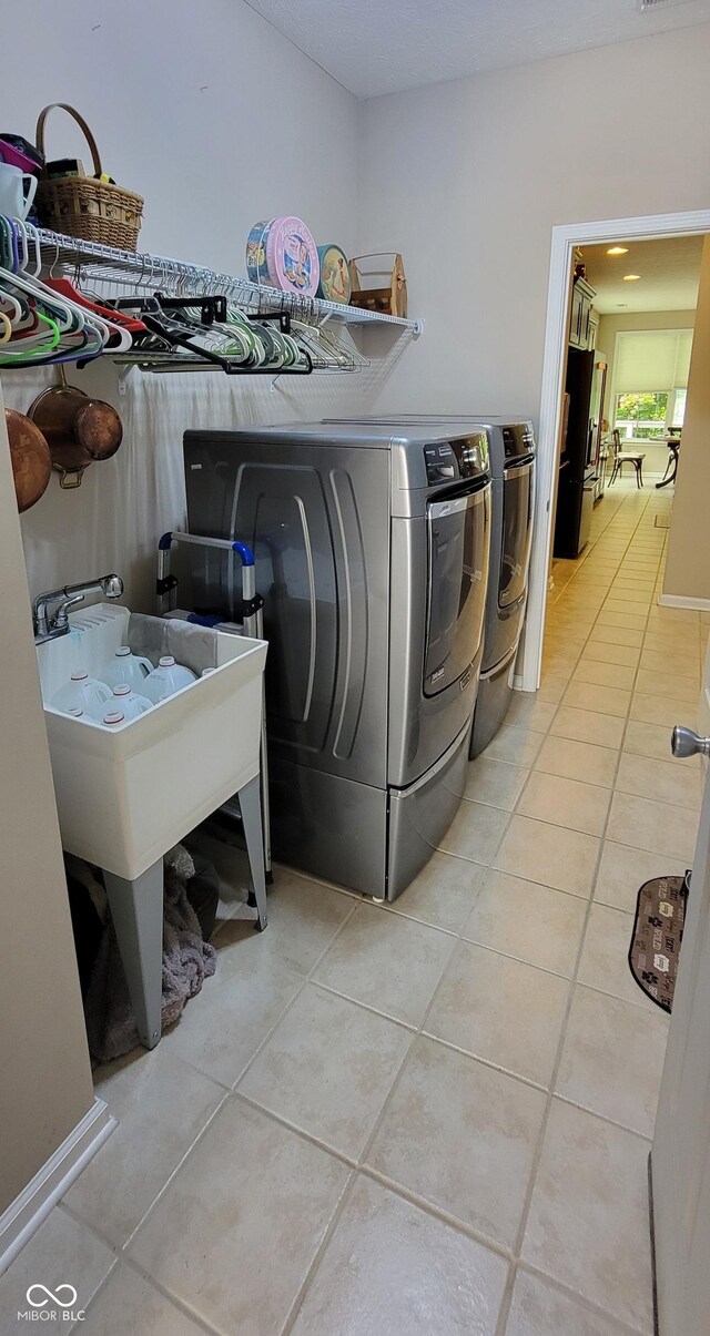 4232 Parliament Way, Avon, IN 46123 - laundry area with light tile patterned floors and washer and clothes dryer