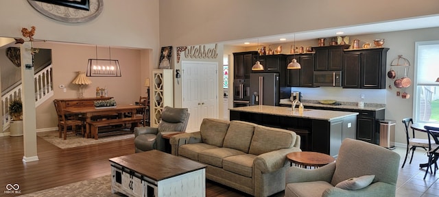 4232 Parliament Way, Avon, IN 46123 - living area with stairs, healthy amount of natural light, baseboards, a towering ceiling, and a chandelier