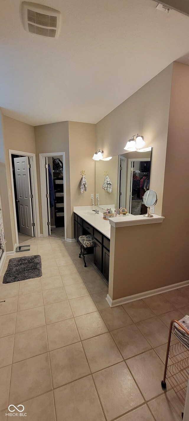 4232 Parliament Way, Avon, IN 46123 - full bathroom featuring a walk in closet, tile patterned flooring, vanity, and baseboards