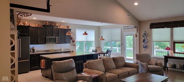 4232 Parliament Way, Avon, IN 46123 - kitchen featuring stainless steel microwave, high quality fridge, a sink, cooktop, and high vaulted ceiling