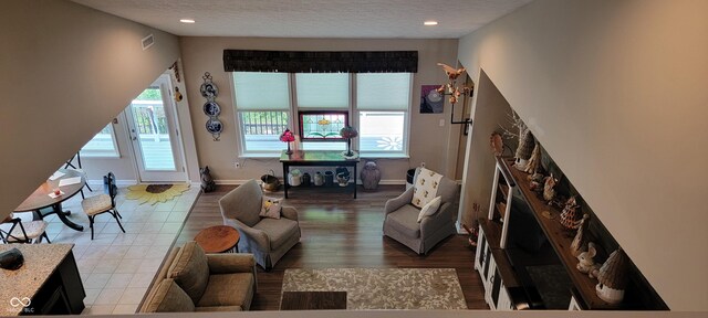 4232 Parliament Way, Avon, IN 46123 - living area featuring a fireplace, baseboards, a textured ceiling, recessed lighting, and light wood-style floors