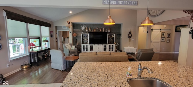 4232 Parliament Way, Avon, IN 46123 - living area featuring a barn door, lofted ceiling, dark wood-style flooring, baseboards, and recessed lighting