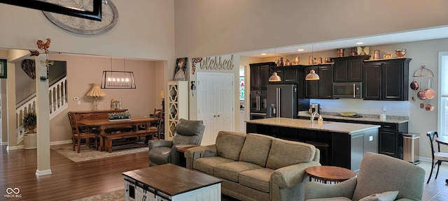 4232 Parliament Way, Avon, IN 46123 - living room with stairway, baseboards, a high ceiling, dark wood-style flooring, and recessed lighting