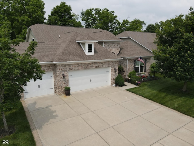 4232 Parliament Way, Avon, IN 46123 - view of front of home featuring concrete driveway, roof with shingles, a front lawn, a garage, and brick siding