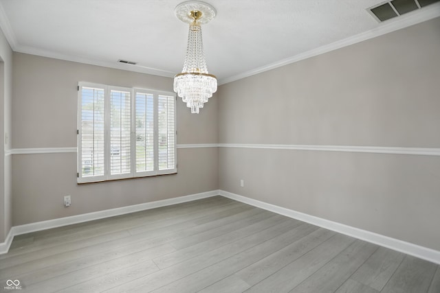10410 Trillium Ct, Noblesville, IN 46060 - unfurnished room with a chandelier, wood finished floors, baseboards, and crown molding