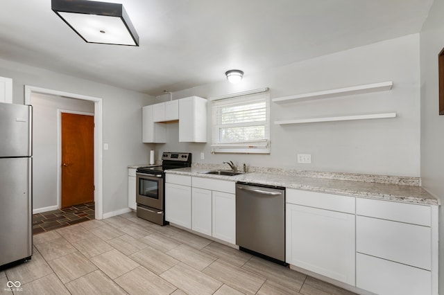 1325 Alimingo Dr, Indianapolis, IN 46260 - kitchen featuring stainless steel appliances, a sink, open shelves, white cabinetry, and light stone countertops