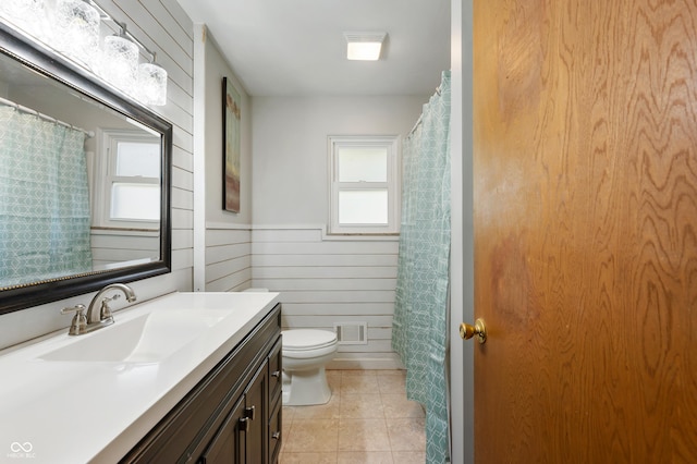 1325 Alimingo Dr, Indianapolis, IN 46260 - bathroom featuring toilet, vanity, tile patterned flooring, wainscoting, and curtained shower