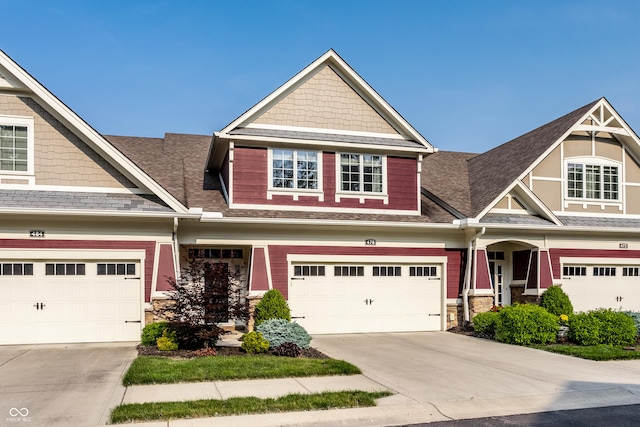 478 Firefly Ln, Carmel, IN 46032 - craftsman-style home featuring driveway, stone siding, roof with shingles, and an attached garage
